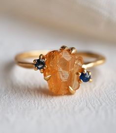 *Gem: Citrine, sapphires (can be customized with other stones as well) *Send us a message to select your favorite citrine gemstones💛🧡 All 12 months birthstones are available for accent stones. Pick any in your choice:) *Metal Solid Silver/14k Gold: These are the metals for durable 24/7 every day wear.  *Our raw stones are hand selected, and set on a beautiful shank for a one-of-a-kind work of art. Every art piece is handmade and varies slightly, just made for the same unique you! *Please note Sapphire Topaz Ring With Gemstone Accents As Gift, Sapphire Crystal Ring Gift, Orange Sapphire Round Ring, Sapphire Crystal Ring With Gemstone Accents For Gift, Orange Gemstone Promise Ring, Gift Orange Topaz Gemstone Ring, Orange Topaz Ring With Accent Stones For Gift, Orange Topaz Ring With Accent Stones As Gift, Orange Topaz Ring With Center Stone For Gift