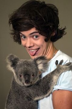 a man holding a koala in his arms