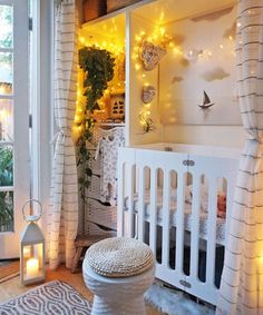 a white crib in a room with lights on the wall