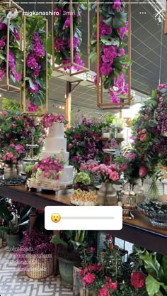 a table topped with lots of purple flowers