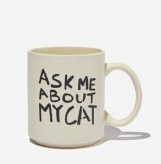 a coffee mug with the words ask me about my cat written on it