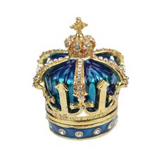 a blue and gold crown with jewels on it's sides, sitting in front of a white background