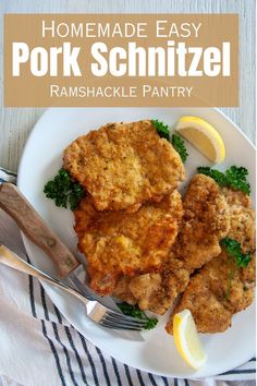 homemade easy pork schnitzel recipe on a white plate with lemon wedges