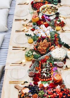 a long table is set up with plates and bowls