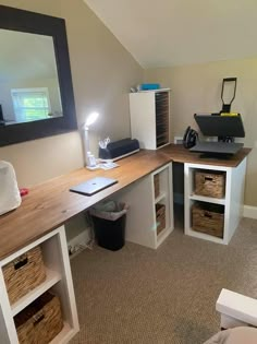 a room with a desk, mirror and other items on the table in it's corner