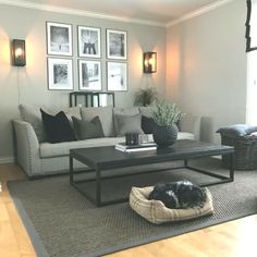 a living room filled with furniture and pictures on the wall above it's coffee table