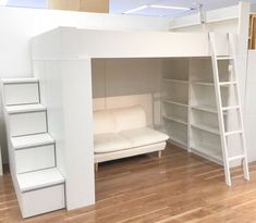 there is a loft bed in the middle of this room with stairs leading up to it