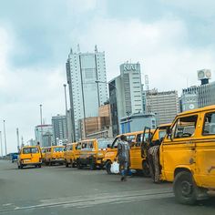 there are many yellow taxi cabs that are parked on the side of the road