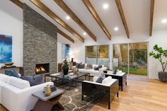 Beverly Hills ranch home living room with chic, warm interior design, stacked slate rustic modern fireplace & artworks. High Ceiling Living Room, Warm Interior