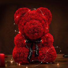 a teddy bear made out of red roses