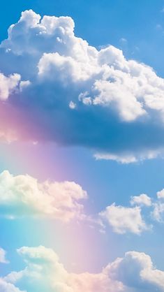 an airplane is flying in the sky with a rainbow colored cloud behind it and blue skies