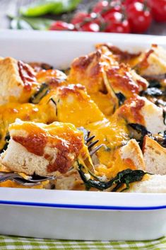 a casserole dish filled with cheese and spinach