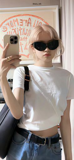 a woman with sunglasses holding up her cell phone