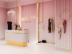 a clothing store with pink walls and gold accents