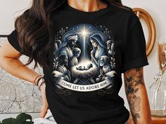 🕊️ Celebrate the true spirit of Christmas with our "Come Let Us Adore Him" T-Shirt! This beautiful nativity scene design captures the essence of the holy night. Perfect for wearing during the holiday season or gifting to loved ones, this shirt is sure to bring joy and peace. Spread love and faith this Christmas! 🎄✨ Product Features: Fabrication: 100% Airlume combed and ring-spun cotton, 32 single 4.2 oz. (Ash - 99% Airlume combed and ring-spun cotton, 1% poly) Seams: Side-seamed Fit: Retail Fi Christian Christmas Gift, Come Let Us Adore Him, Scene Design, Christian Tees, Christian Christmas, Holy Family, Holy Night, Christmas Nativity, Unique Christmas Gifts