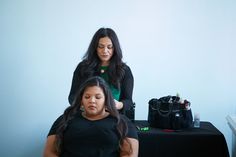 the woman is getting her hair done at the same time as the lady in the mirror