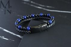 This bracelet comes with genuine black braided leather, 6mm Lapis and Onyx beads and a black IP plated stainless steel clasp. - Materials: Dyed Blue Leather, 316L Stainless Steel, Lapis and Onyx Beads - Plating: Black IP Plating - Bracelet Clasp: Magnetic Clasp - Bracelet Width: 12mm - Beads: 6mm Lapis and Onyx Beads ✔ Resistant to Rusting, Greening and Fading ✔ Waterproof, Heatproof, Sweatproof & Hypoallergenic ✔ Comes with a Black Velvet Gift Bag ■ Personalised Engraving Personalised Bracelet Spiritual Beaded Black Wrap Bracelet, Adjustable Black Braided Beaded Bracelets, Spiritual Black Beaded Wrap Bracelet, Black Beaded Braided Bracelet, Black Spiritual Wrap Bracelet With Round Beads, Handmade Black Spiritual Leather Bracelet, Casual Black Hand Wrapped Braided Bracelets, Elegant Black Beaded Leather Bracelet, Casual Black Hand Wrapped Braided Bracelet