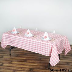 the table is covered with pink and white checkered cloth