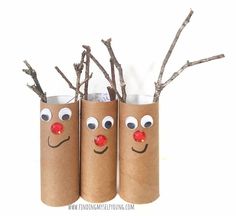 three toilet paper tubes with reindeer noses on them and branches sticking out of the top