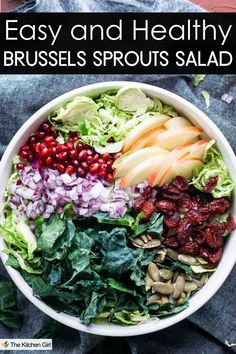 A bowl of Brussels sprouts salad featuring shredded Brussels sprouts, sliced apples, pomegranate seeds, chopped red onion, kale, dried cranberries, and pumpkin seeds. The image has text: Easy and Healthy Brussels Sprouts Salad. Salad With Apple Cider Vinaigrette, Garlic Brussel Sprouts, Shaved Brussel Sprout Salad, Shaved Brussel Sprouts, Brussels Sprout Salad, Cider Vinaigrette, Sprout Salad, Winter Meals, Healthy Rice