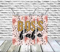 a sign that says boss babe on it in front of a brick wall with pink roses