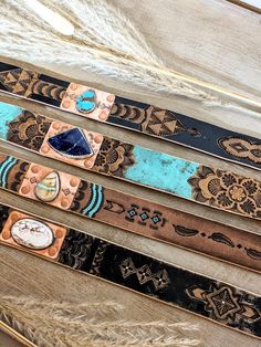 "Handmade Leather Hat Bands, Adjustable to fit any hat, these are easy to switch from hat to hat! These are Artisan Hat Bands, absolutely One of a Kind! They feature incredible detail and timeless Western design. All the components used in these hat bands are genuine and of the finest quality. Please read below for details... A - Sierra Nevada Turquoise Stone Features a beautiful teardrop of bright Sierra Nevada turquoise stone wrapped in a band of solid Sterling Silver and sitting on a rectangle of solid copper, featuring hand stamped designs. The copper rectangle is permanently riveted in place on the leather. The leather is top quality cowhide with hand tooled designs, and is 22\" long, and 1.25\" wide. It has been dyed, hand painted, distressed and antiqued all by hand. Soft Deerskin l Unique Adjustable Hat Bands For Festivals, Unique Adjustable Brown Hat Bands, Bohemian Handmade Hat Bands For Gift, Custom Handmade Hat Band For Gift, Artisan Adjustable Hat As A Gift, Artisan Adjustable Hat As Gift, Adjustable Artisan Hat As A Gift, Handmade Artisan Brown Hat Bands, Handmade Artisan Adjustable Hat Bands