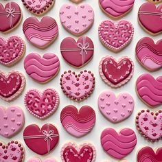 heart shaped cookies are arranged on a white surface