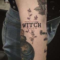 a person with a tattoo on their arm that says, there's a little witch in all of us