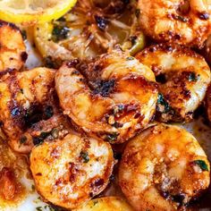 grilled shrimp with lemon wedges and herbs