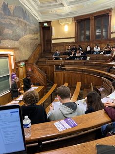 people sitting at desks in a lecture hall