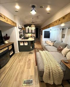 a living room filled with furniture and a flat screen tv on top of a hard wood floor