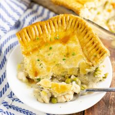 a chicken pot pie on a plate with a fork