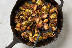 brussel sprouts in a cast iron skillet with a spoon