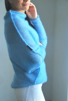 "Light jeans blue soft mohair cardigan, mohair silk poncho, blue soft mohair pullover, light blue mohair shawl, jeans blue mohair sweater So comfy, fuss free and great for layering. Balance the dramatic draping with leggings or your favourite skinny jeans. Go for a casual, lived in feel or dress it up for a dramatic evening look, depending on your mood. Can be worn open or belted. Will work well for maternity wear as well. Light weight jersey knit. Content + Care - 75% mohair, 25 % silk - Hand w Casual Blue Mohair Sweater, Blue Alpaca Long Sleeve Sweater, Blue Long Sleeve Alpaca Sweater, Cozy Blue Mohair Sweater, Soft Textured Blue Sweater For Winter, Fall Blue Alpaca Sweater, Silk Poncho, Mohair Shawl, Wedding Sweater