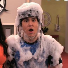 two people dressed up in costumes with snow on their heads and one person making a surprised face