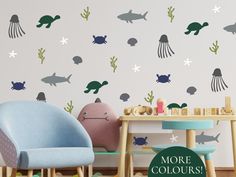 a child's room with wall decals that include sea animals, fish and jellyfish