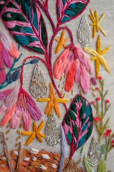 the embroidery work is colorful and has flowers on it