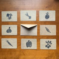 a wooden table topped with cards and envelopes