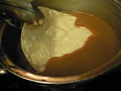 a pot filled with liquid and flour on top of a stove