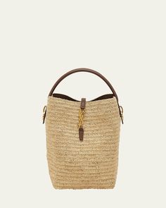 Saint Laurent "Le 37" bucket bag in raffia and leather     Flat top handle, 3.5" drop    Detachable, adjustable crossbody strap, 15.7"L    Can be worn as a top handle, shoulder, or crossbody bag     Open top with center YSL strap     Bronze hardware     Feet protect the bottom of bag     Approx. 9.8"H x 7.8"W x 6.2"D    Imported Chic Essentials, Raffia Bucket Bag, Bronze Hardware, Modern Wardrobe, Crochet Bags, Style And Grace, Flats Top, Knitted Bags, Open Top