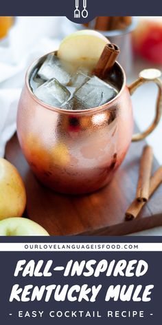 an apple cider bourbon mule is served in a copper mug with cinnamon sticks and apples