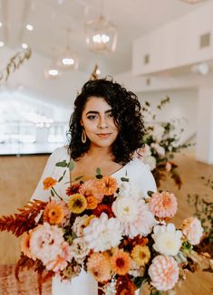 a woman holding a large bouquet of flowers