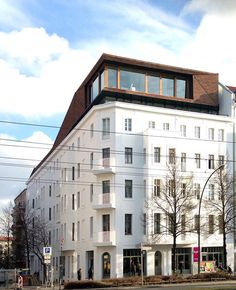 a large white building sitting on the side of a road