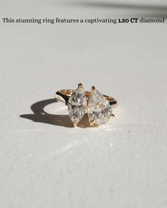 two pear shaped diamond rings sitting on top of a white surface with the caption, this stunning ring features a captivating lg ct diamond