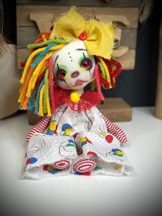 a doll with colorful hair sitting on top of a table