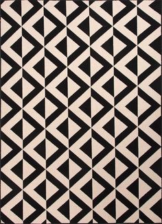 a black and white rug with an abstract design