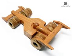 a wooden toy airplane made out of wood with wheels on the front and back sides