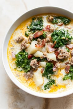 a white bowl filled with soup and meat