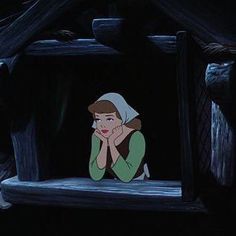 an animated scene of a woman sitting on a bed with her hands to her face