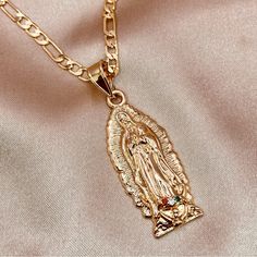 This Pendant Is A Beautiful And Unique Piece Of Jewelry That Features A 3d Textured Design Of The Virgin Mary. The Pendant Is Inlaid With Tiny Zirconia, Which Adds A Touch Of Sparkle And Elegance To The Design. The 3d Textured Design Of The Pendant Adds Depth And Dimension, Making It More Visually Appealing And Interesting To Look At. The Pendant Is Designed To Be Worn With A Figaro Necklace, Which Is A Classic And Versatile Style That Can Be Worn With A Variety Of Outfits And For Different Occasions. The Figaro Necklace Is A Popular Choice For Jewelry Because It Is Comfortable To Wear And Can Be Easily Adjusted To Fit Different Neck Sizes. Mother Of Pearl Cubic Zirconia 14k Y 3d Pendant, Virgin Mary Necklace, Figaro Necklace, Catholic Jewelry, The Virgin Mary, Of Outfits, Textured Design, Our Lady, Virgin Mary